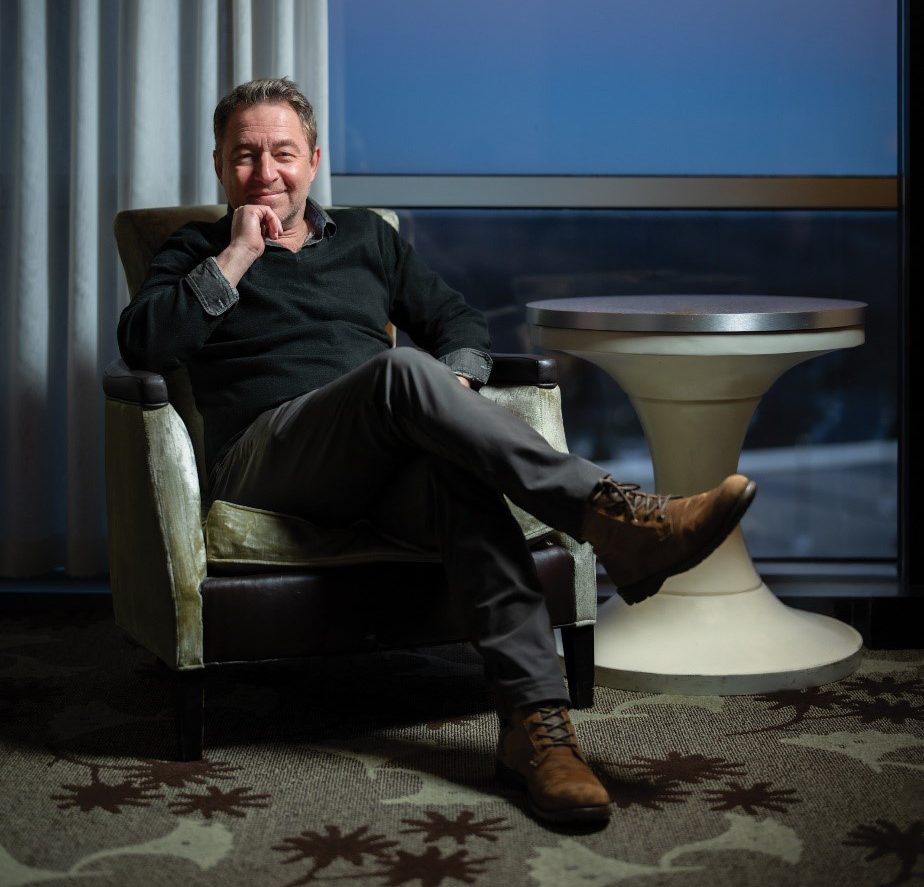 A man sits on a chair.