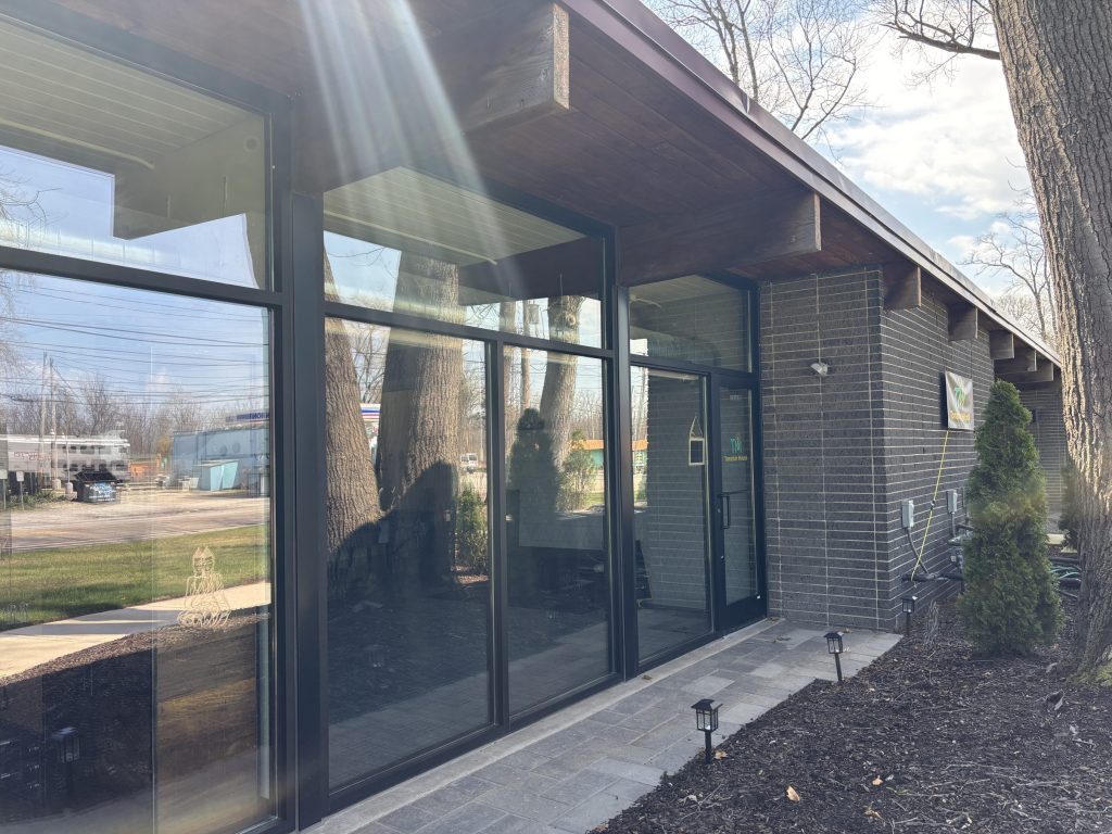 A midcentury building with large glass windows.